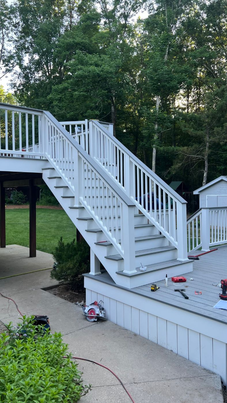 Two-level deck with white stairs and railings in Johnston, RI