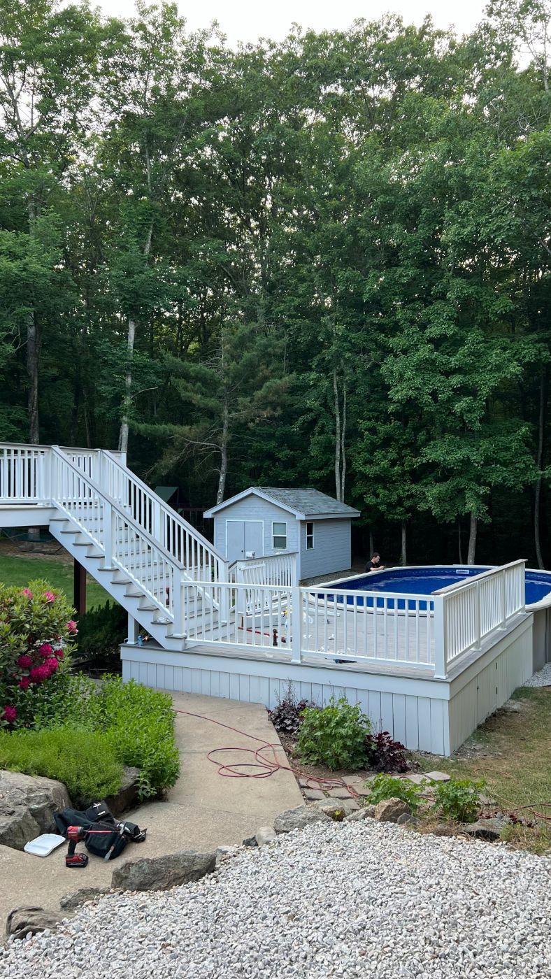 Pool deck with white railings and skirting in Johnston, RI