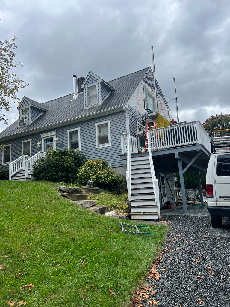 New blue siding and white deck stairs on a home in Tiverton, RI